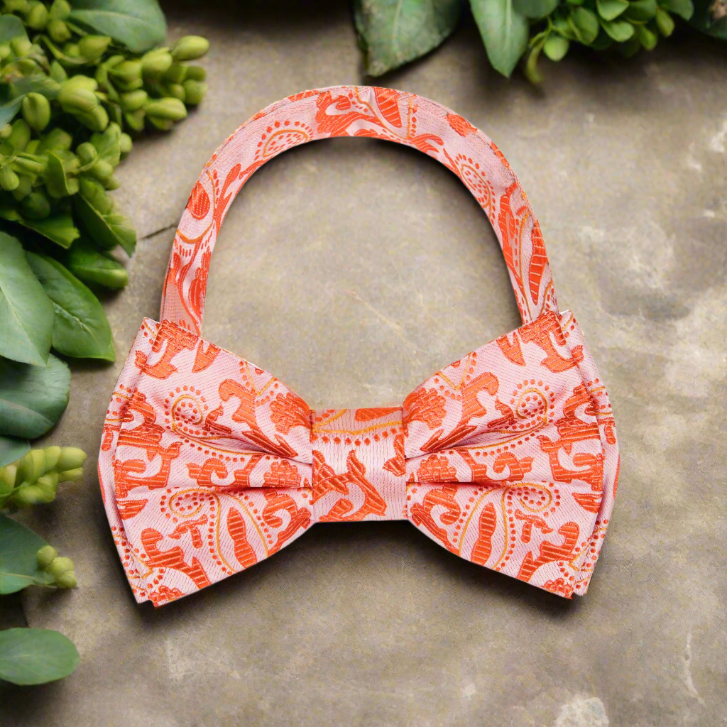 Bow tie laid out on a light blue dress shirt for a sophisticated ensemble.