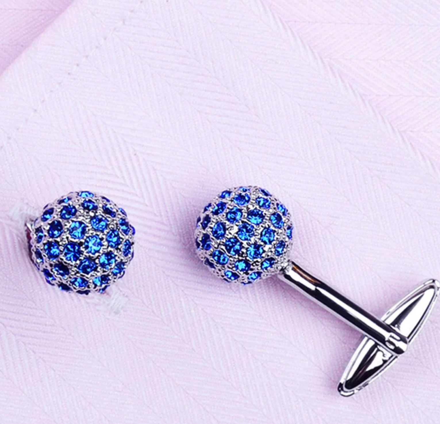 Close-up of the circular cufflinks highlighting the small stones and chrome finish