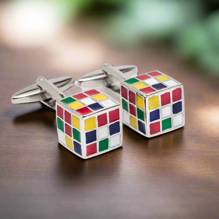 Vibrant chrome cufflinks with multicolor enamel shapes displayed on a white dress shirt.