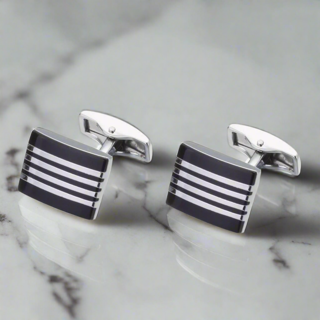 Close-up of mens cufflinks with chrome and black finish, stylish for formal wear