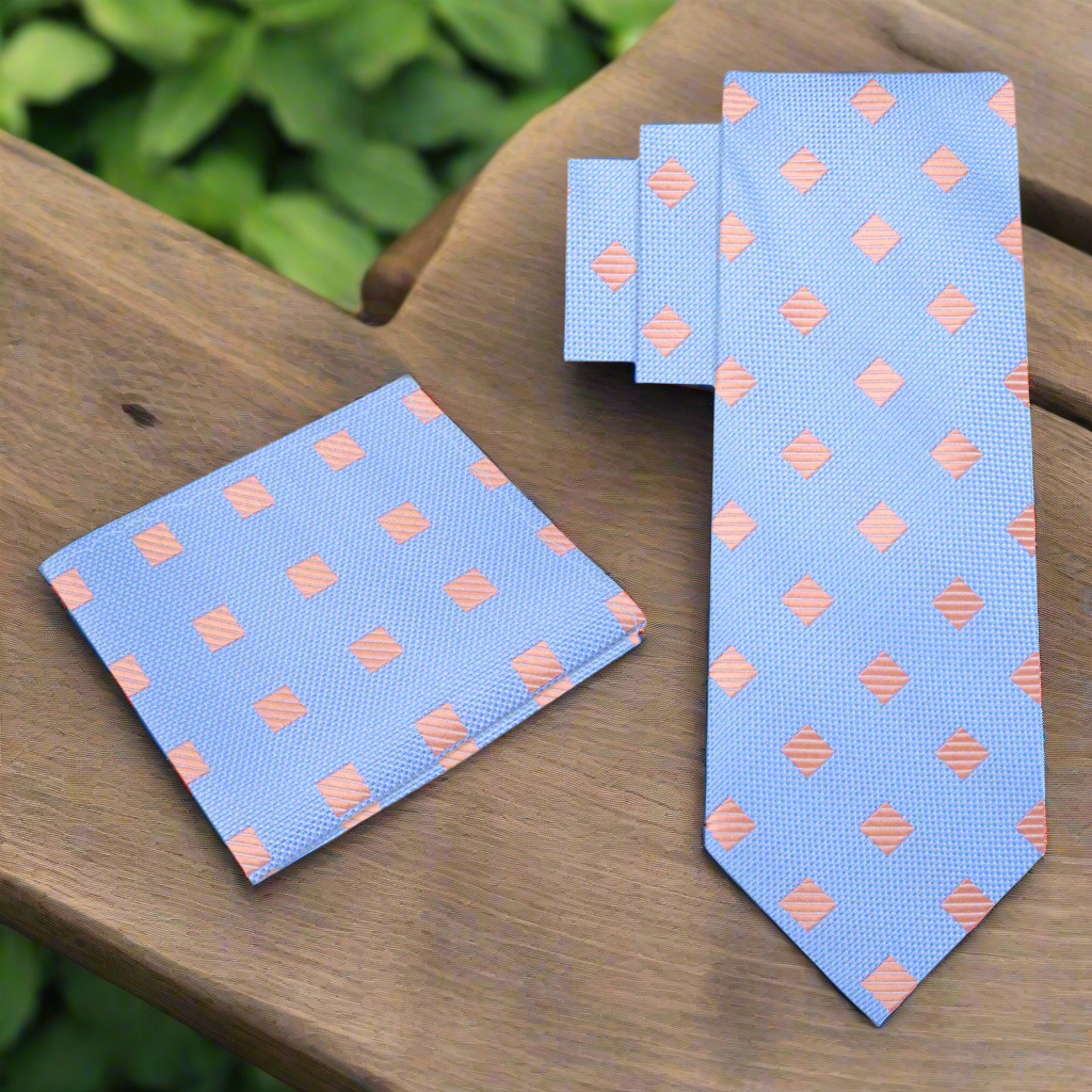 Vibrant geometric diamond patterned necktie in cyan blue and salmon for weddings and formal events