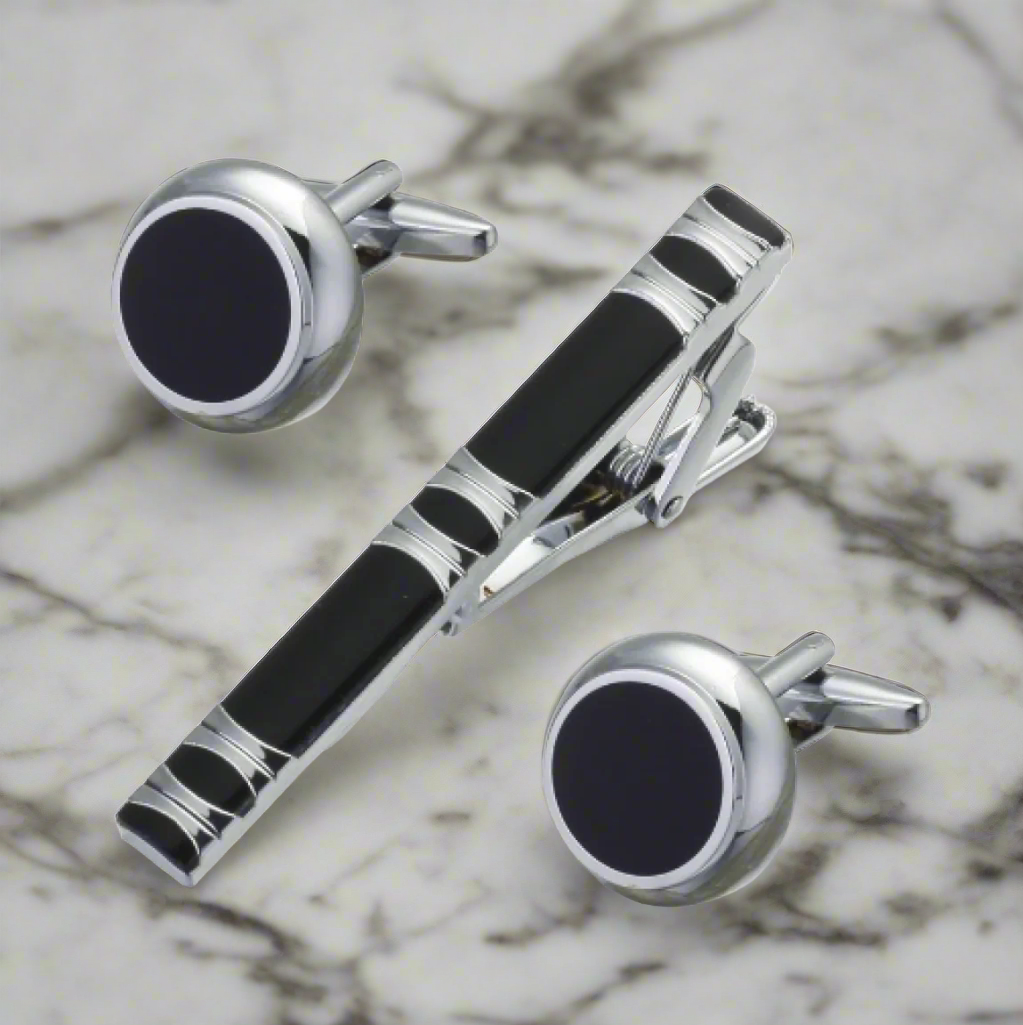 Close-up of the chrome tie bar and black cufflinks
