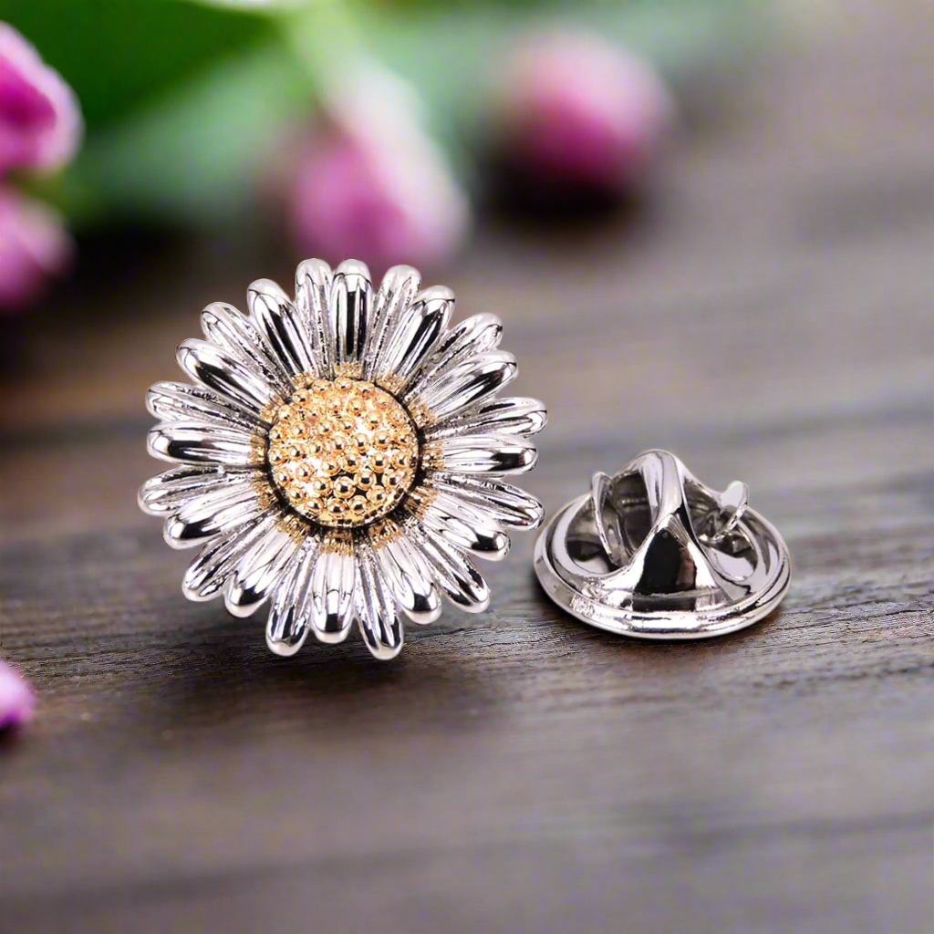 Close-up of the charming daisy lapel pin in chrome, highlighting its intricate design and shine.