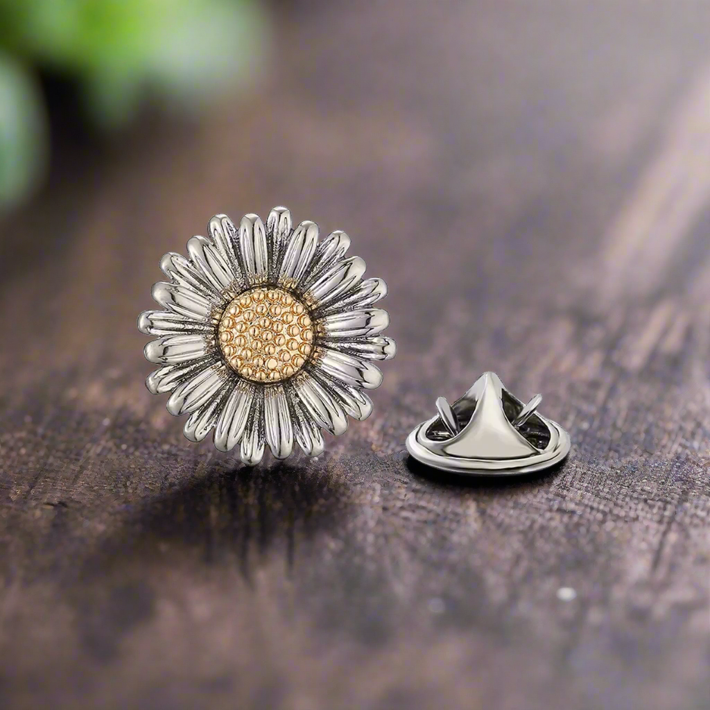 Daisy lapel pin styled on a light grey linen suit, perfect for spring weddings.