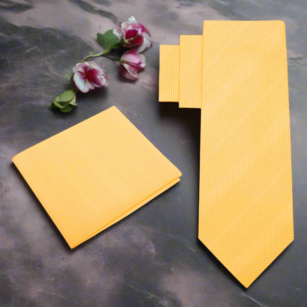 Vibrant dandelion yellow silk necktie draped elegantly on a wooden surface, perfect for weddings and formal events.