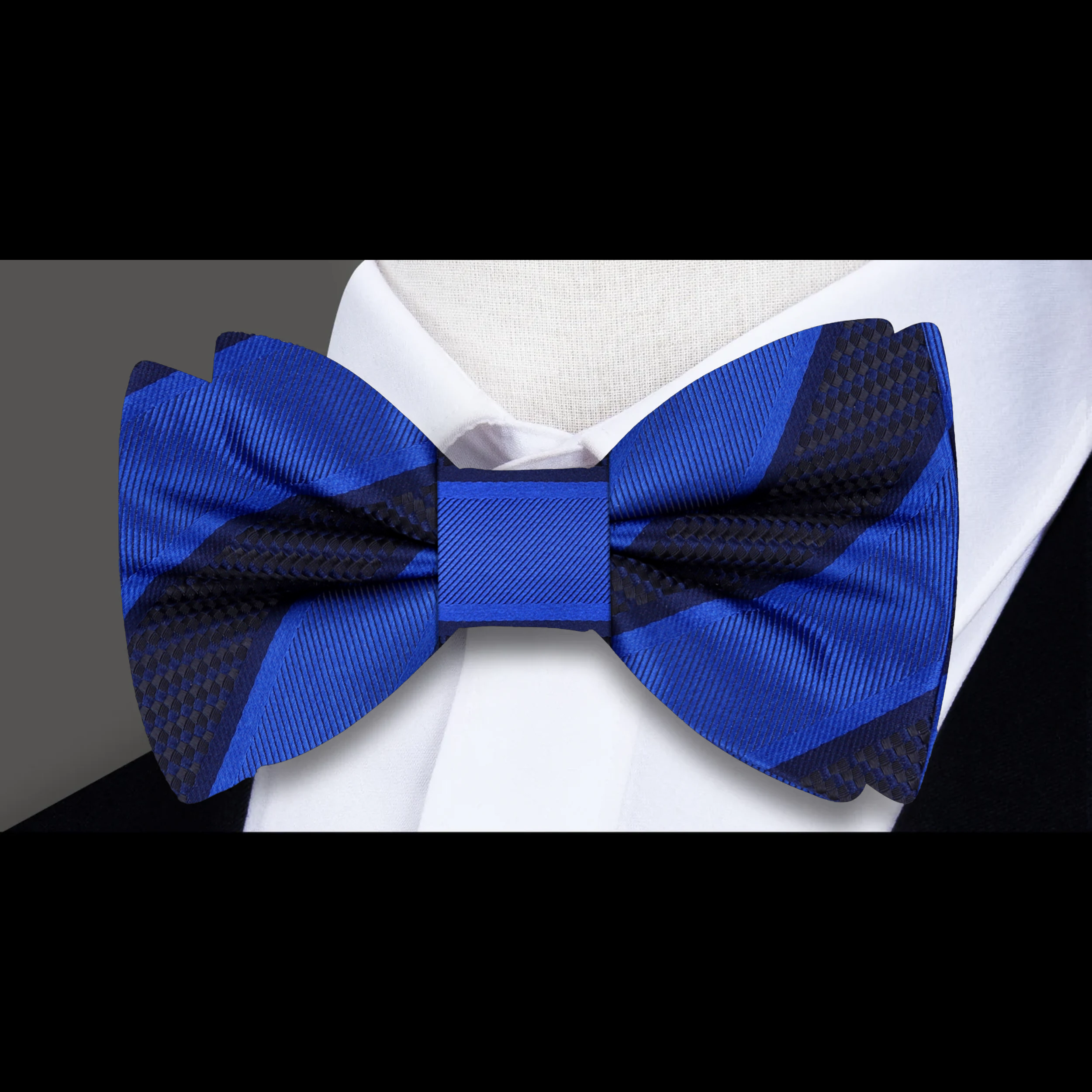 Close-up of the fabric pattern and texture of a yellow gold striped bow tie