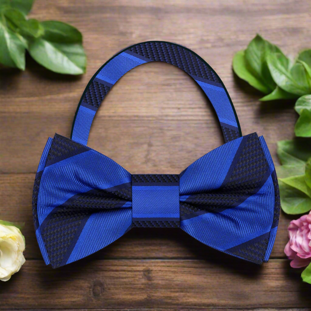 Model wearing a silk striped bow tie with a navy suit for a formal event