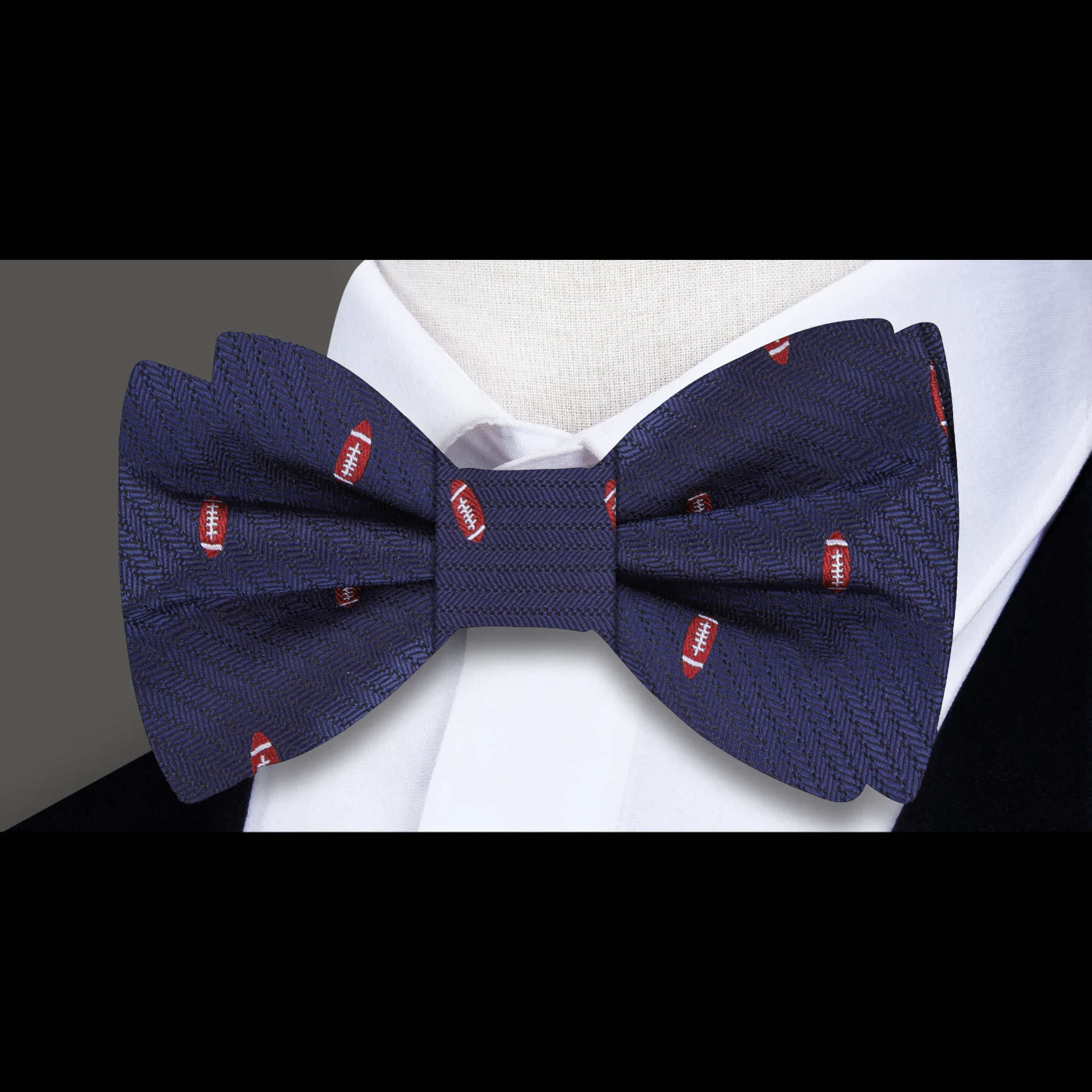 Red and brown football patterned silk bow tie paired with a matching pocket square.