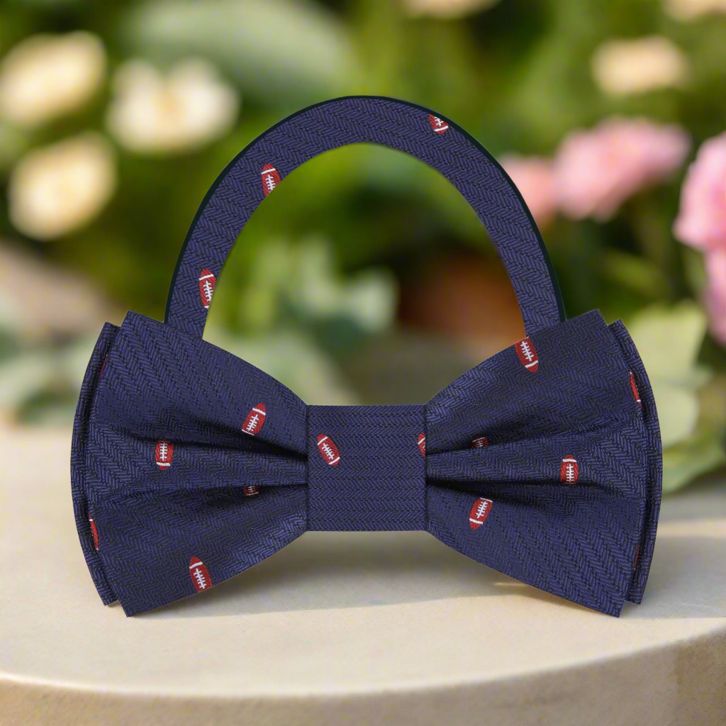 Close-up of the intricate football pattern on a silk bow tie, showcasing its luxurious fabric.