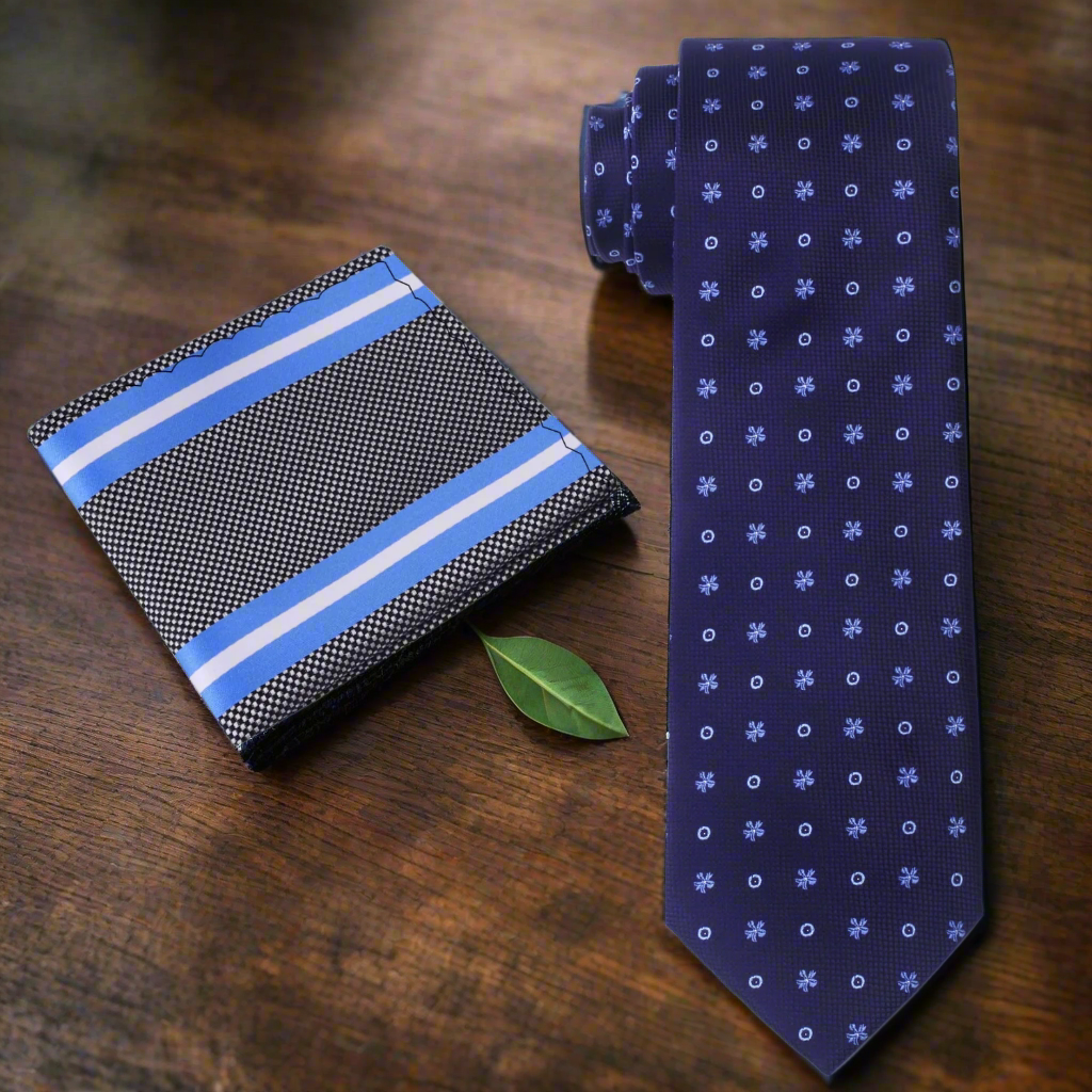 Model wearing a dark blue silk tie with a charcoal grey suit at a business presentation.