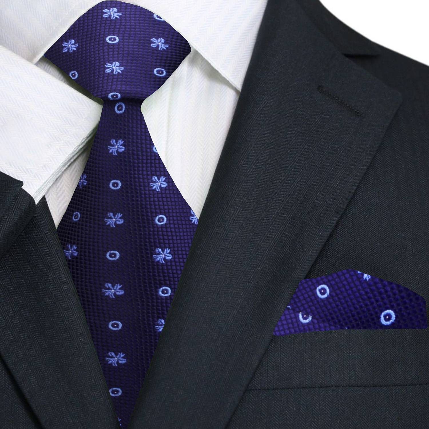 Dark blue silk tie with geometric pattern displayed on a wooden surface.