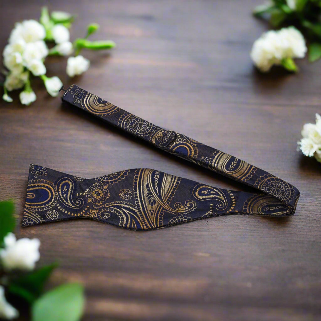 Man adjusting a sophisticated paisley bow tie for a formal event