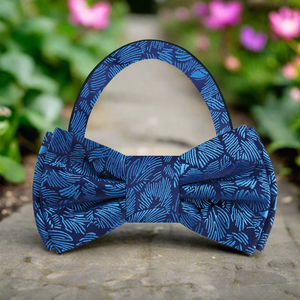 Man wearing adjustable blue bow tie at outdoor wedding