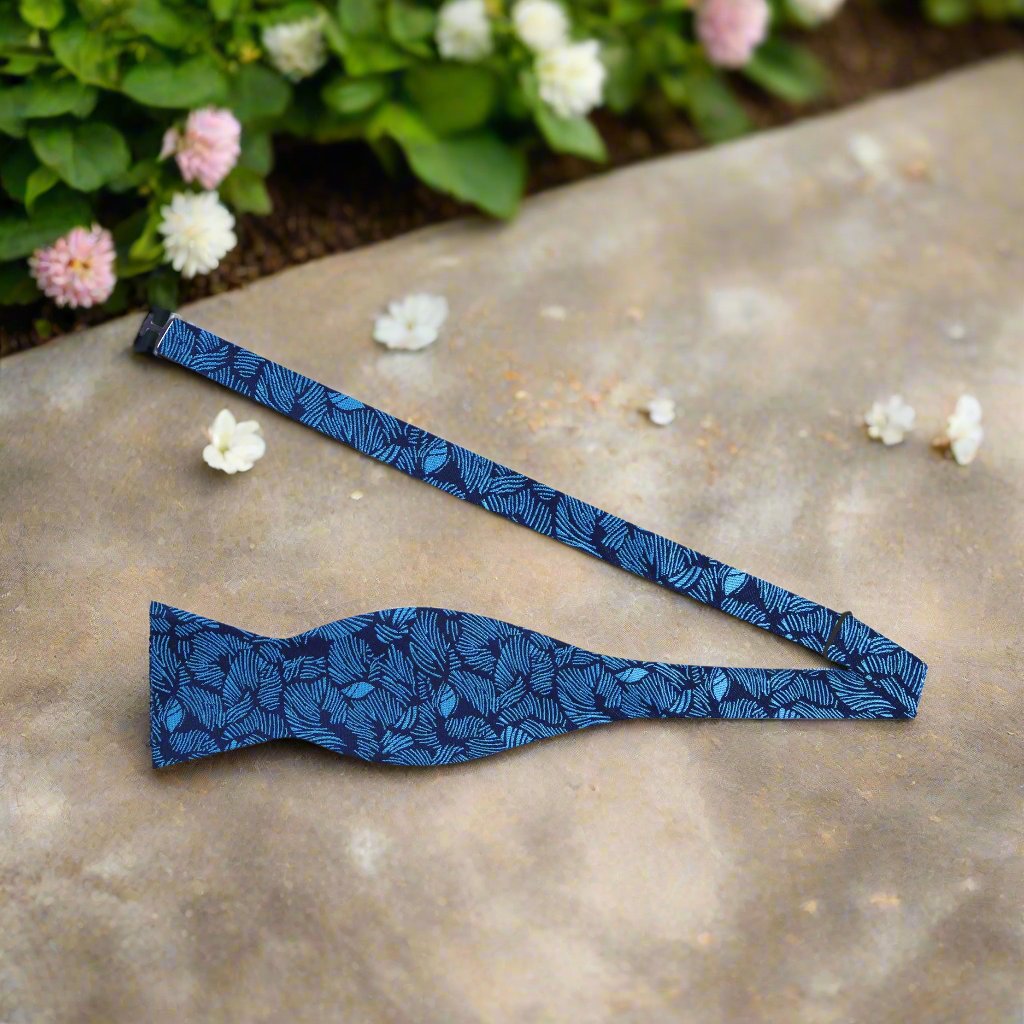 Close-up of navy silk bow tie with leaf pattern for formal events