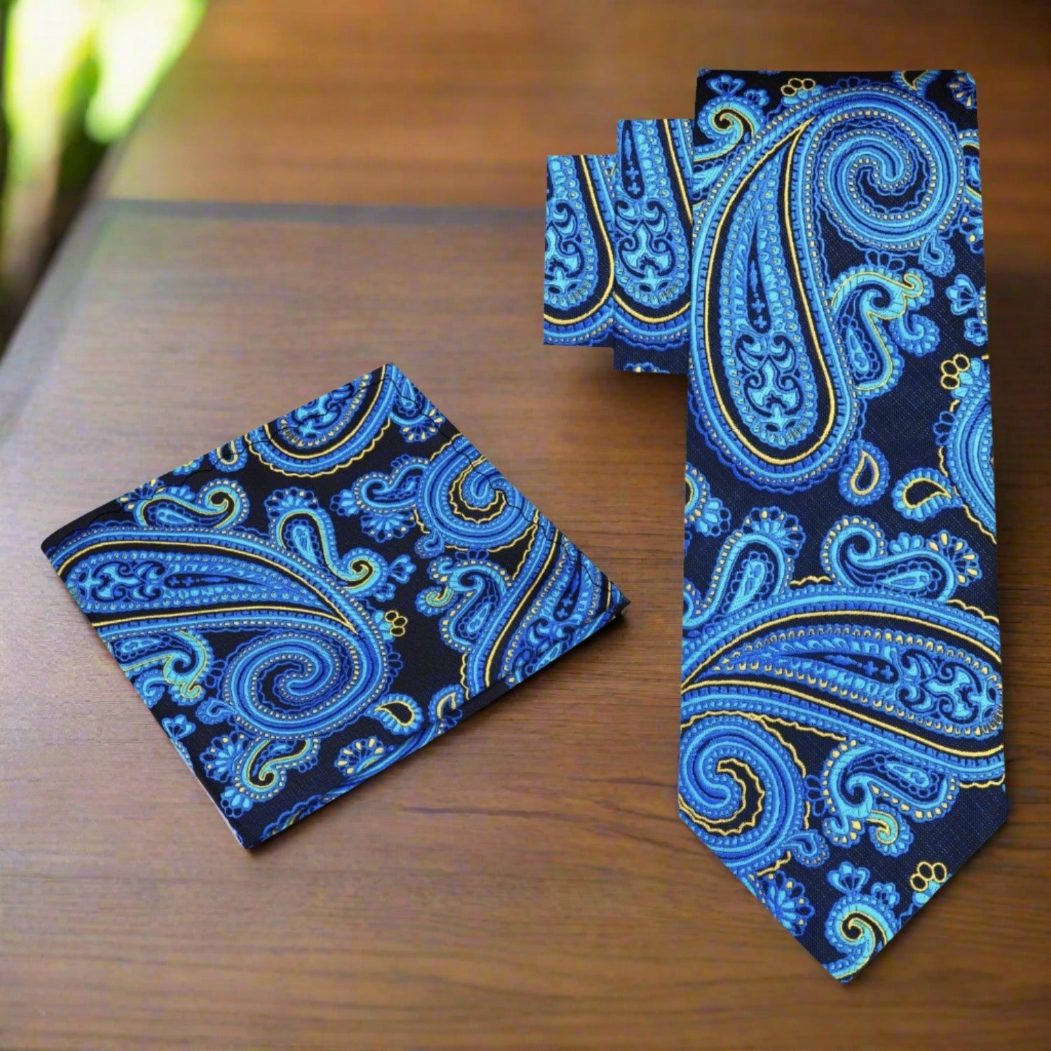 Close-up of a blue paisley tie, highlighting the vibrant colors and luxurious silk fabric, suitable for business meetings.
