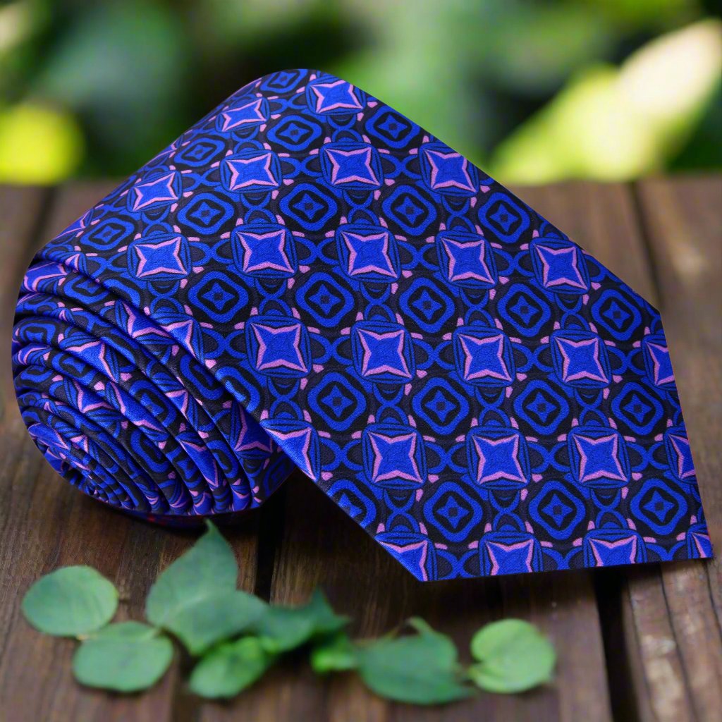 Close-up of silk tie showing medallion pattern in black, purple, and blue — ideal for formal wear.