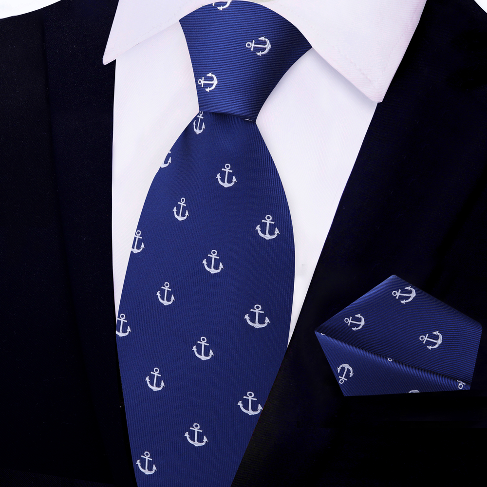 Anchor necktie in blue and grey paired with a light grey suit for business casual look