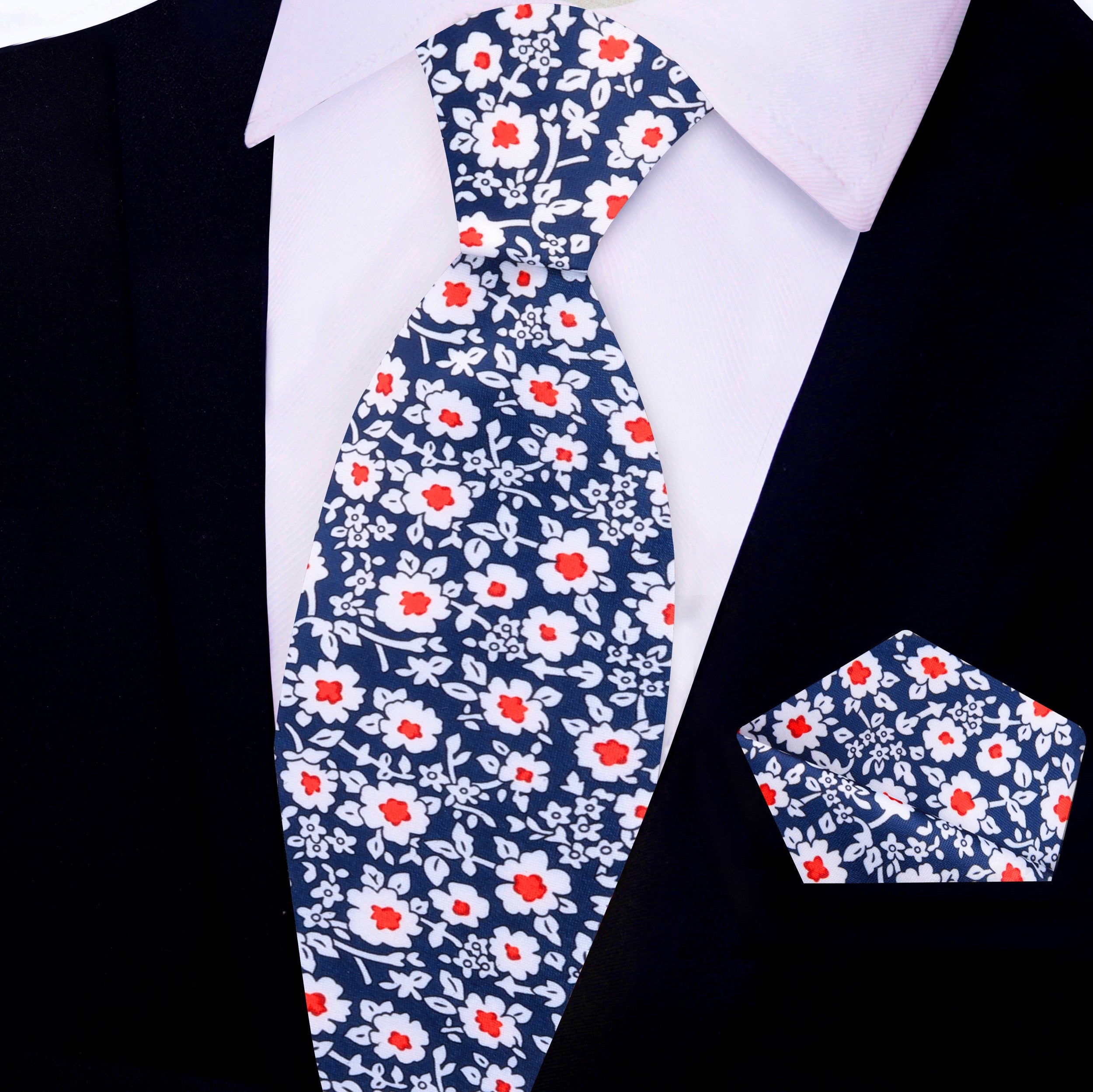 Model wearing the blue and red floral tie paired with a suit, demonstrating its suitability for formal occasions.