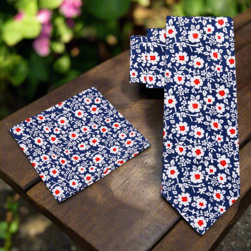 Close-up of the elegant blue and red floral silk necktie showcasing intricate flower patterns, perfect for a wedding.