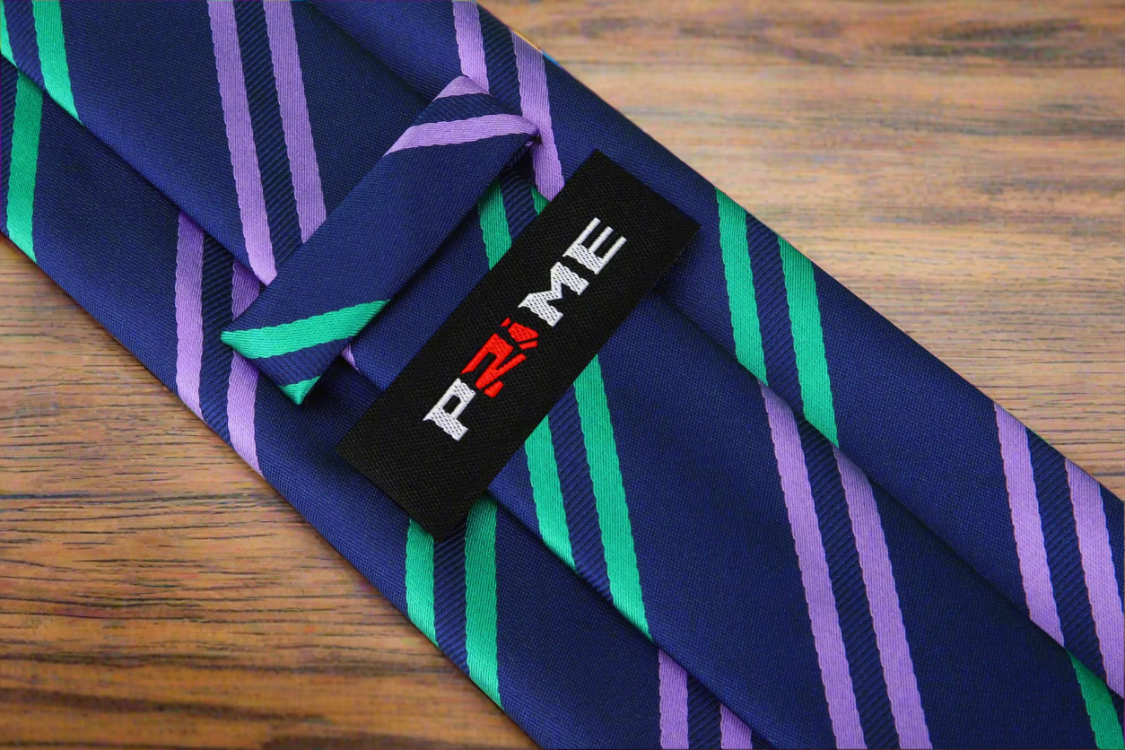 Close-up of Royal Striped Silk Necktie with intricate detailing in dark blue, green, and purple.