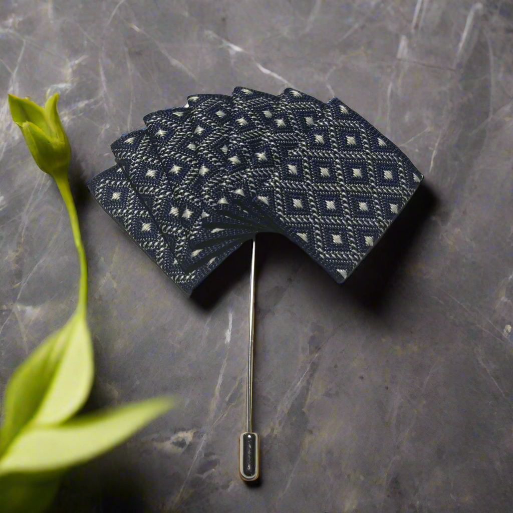Elegant lapel pin pocket square set in blue with grey edges, showcasing versatility.