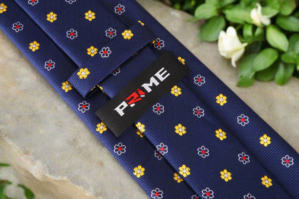 Elegant Blue Floral Silk Necktie paired with a crisp white dress shirt for a formal look.