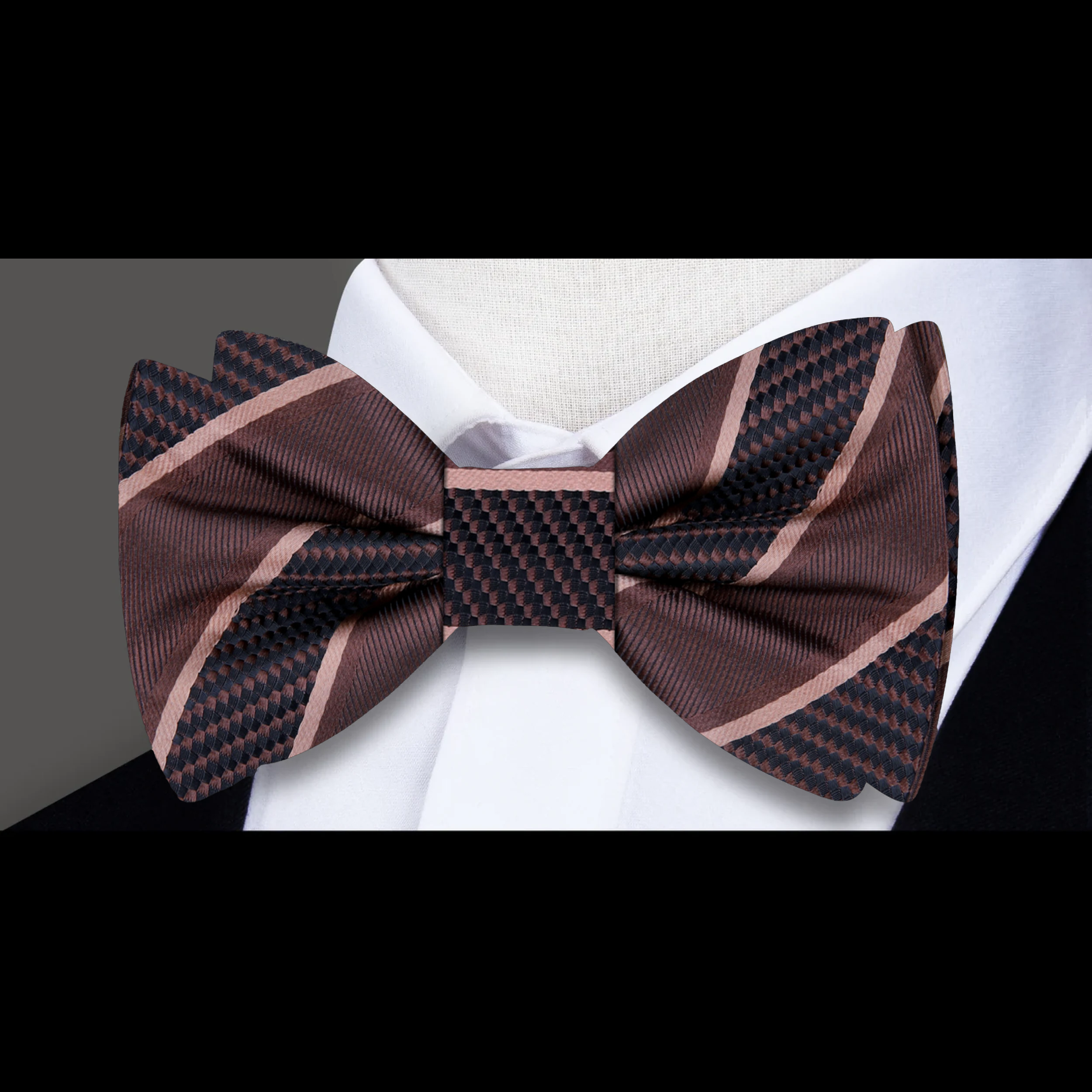 Close-up of the fabric pattern and texture of a yellow gold striped bow tie
