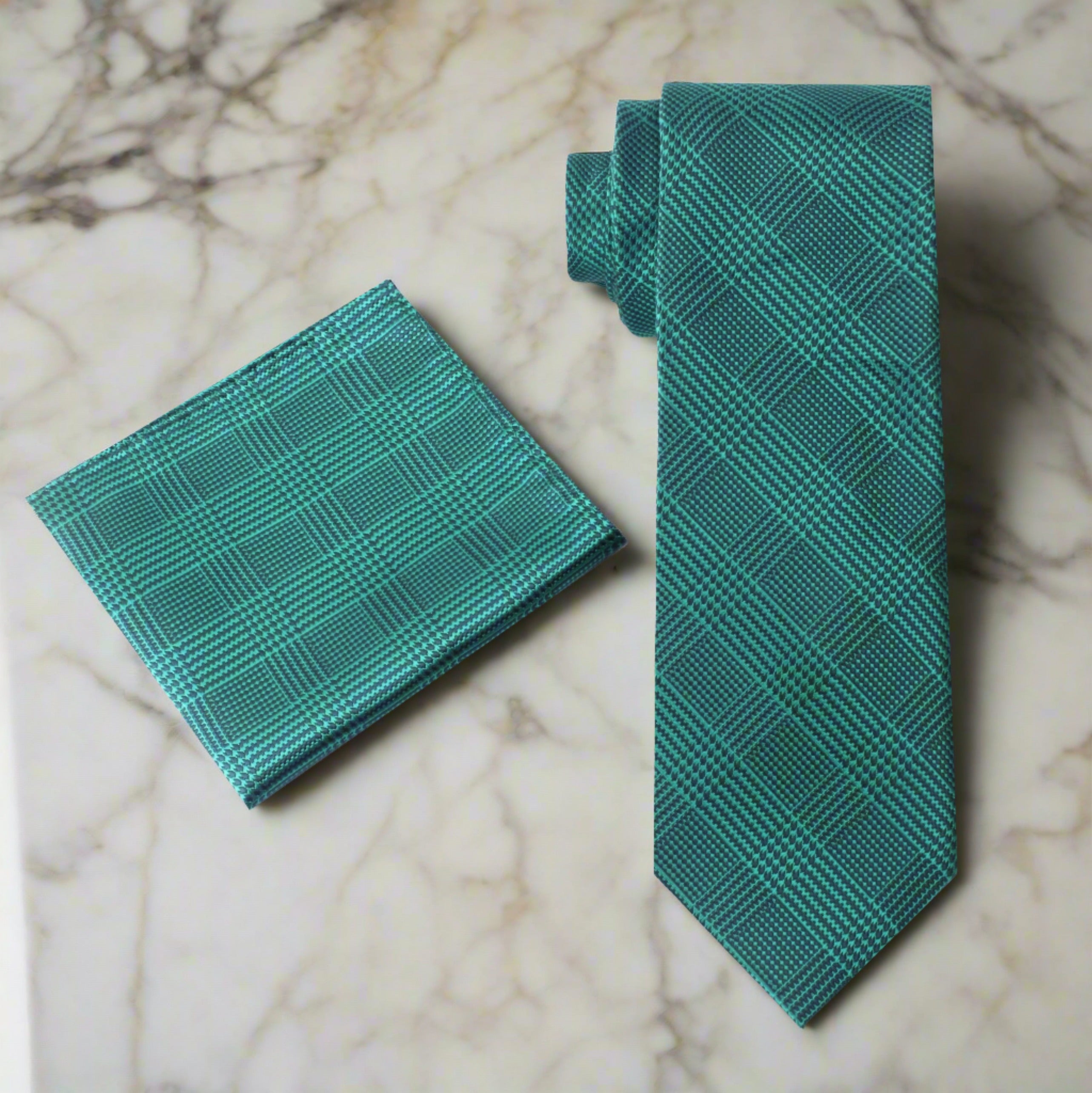 Front view of green and dark blue plaid silk necktie with a white dress shirt