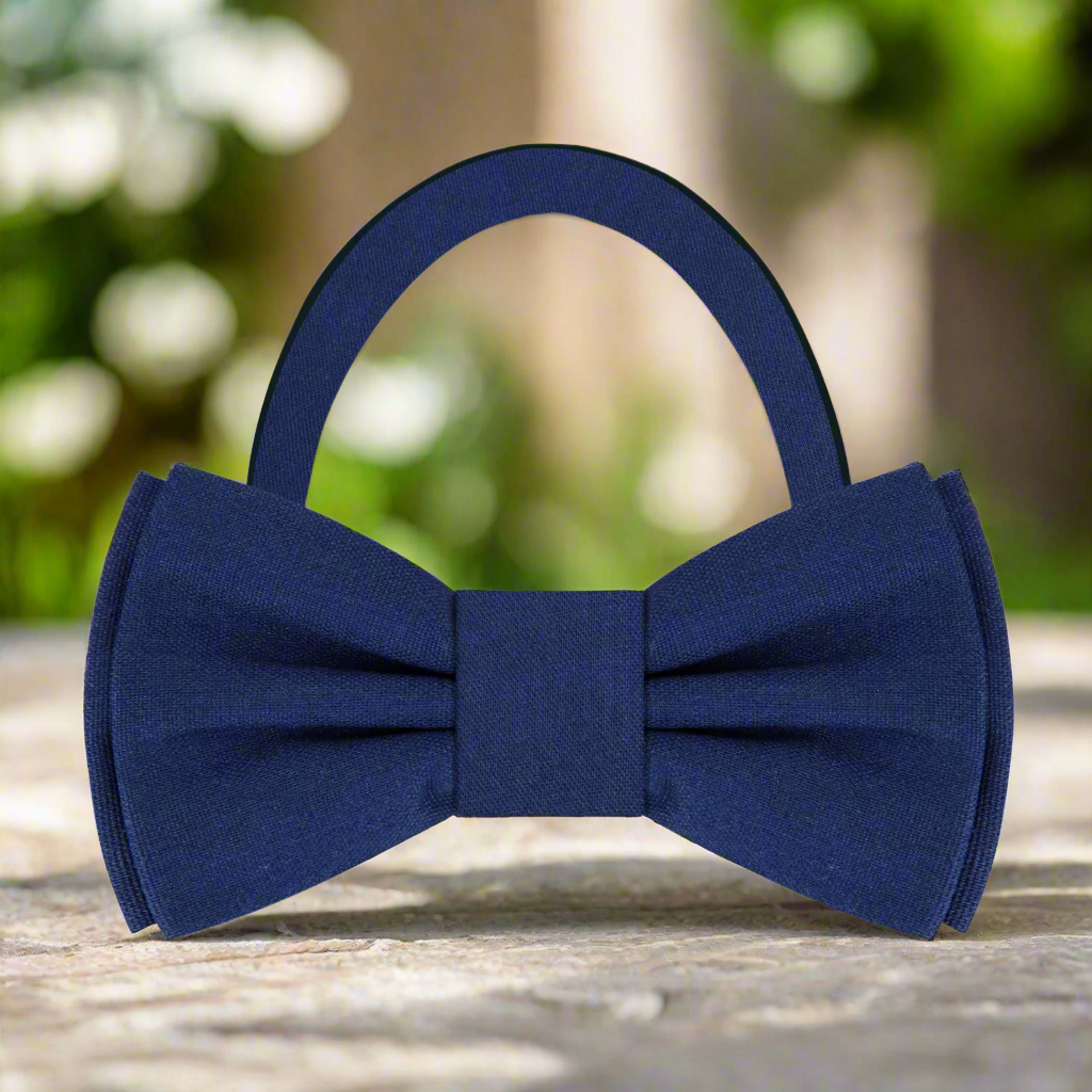 Fashionable man adjusting a deep red linen bow tie, showcasing effortless elegance