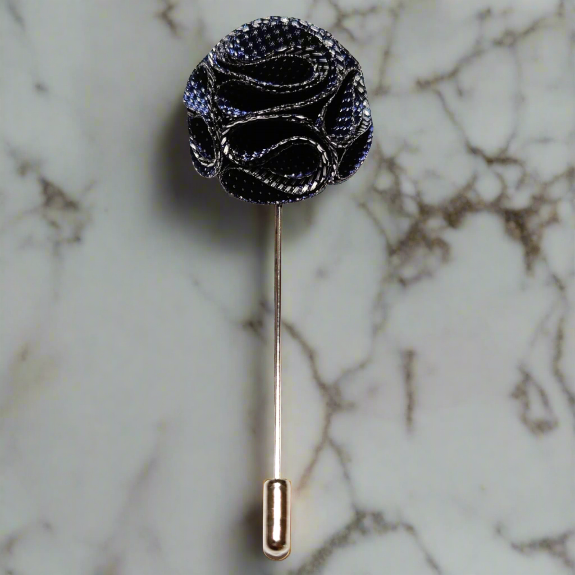 Close-up of a high-quality flower pin with textured fabric and zinc alloy backing