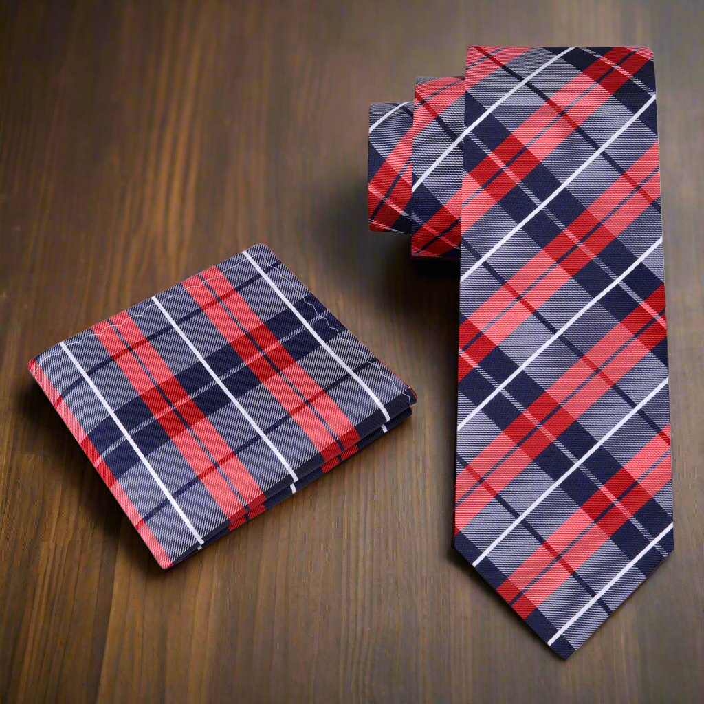The plaid silk necktie paired with a crisp white dress shirt, ideal for a professional setting.
