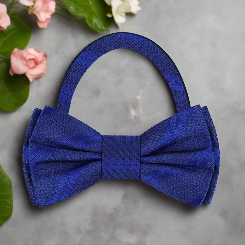 Close-up of dark blue silk bow tie with detailed stripe pattern for formal wear