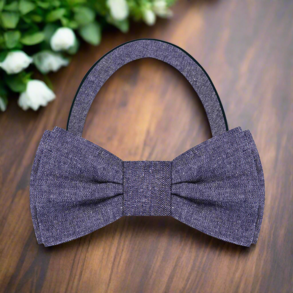 Fashionable man adjusting a deep red linen bow tie, showcasing effortless elegance