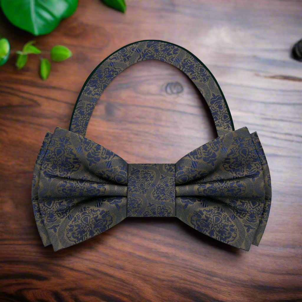 Close-up of the expressive abstract silk bow tie showcasing its vibrant brown and blue pattern.