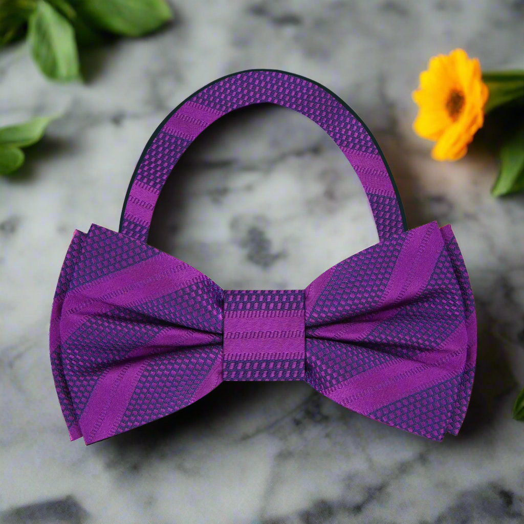 Close-up of dark blue silk bow tie with detailed stripe pattern for formal wear