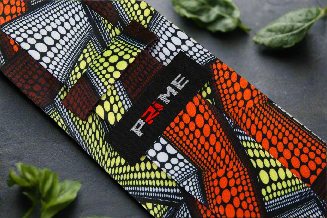 Detail shot of geometric Kente inspired design on a luxurious silk necktie