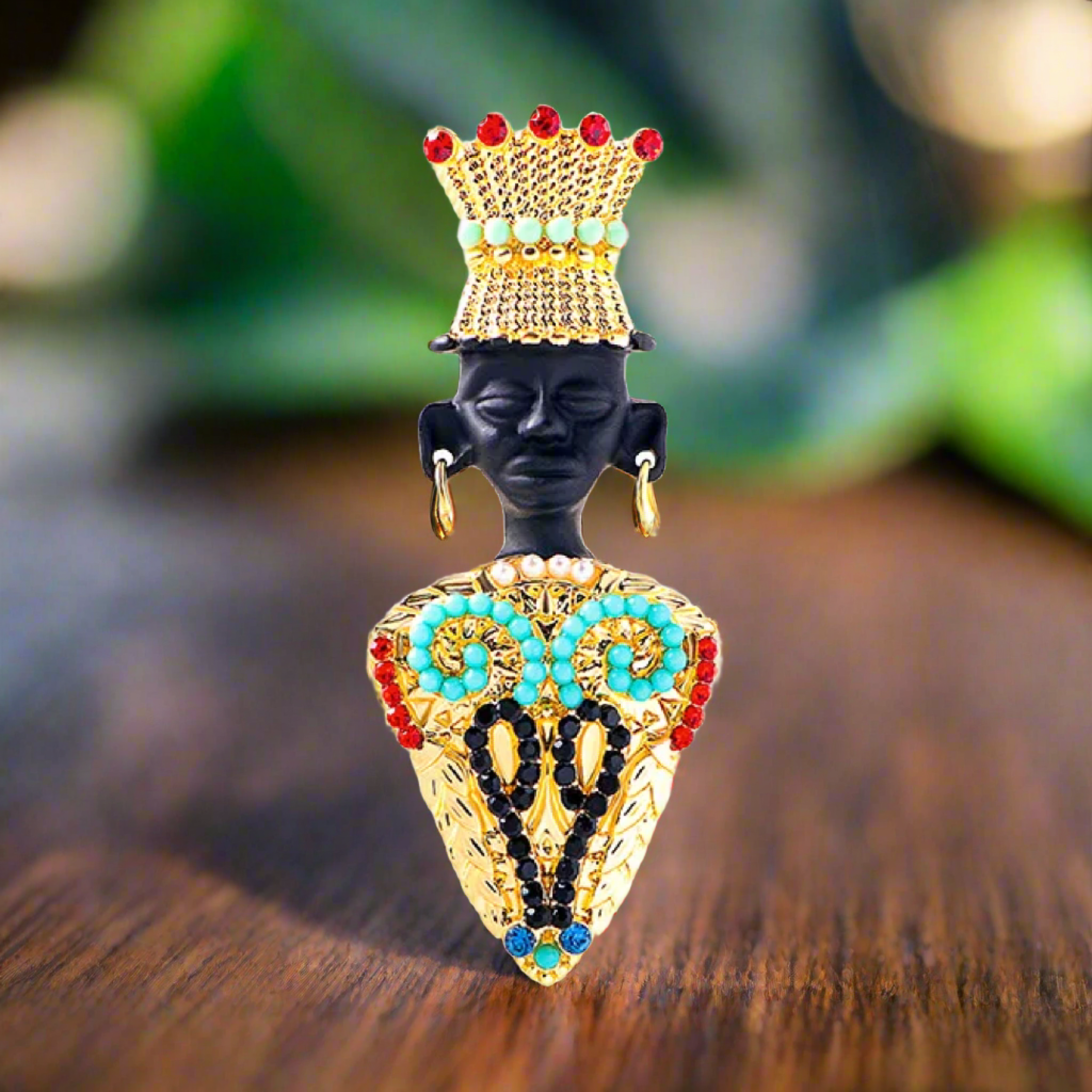 The luxurious Egyptian style lapel pin worn on a green blazer, highlighting its opulence.