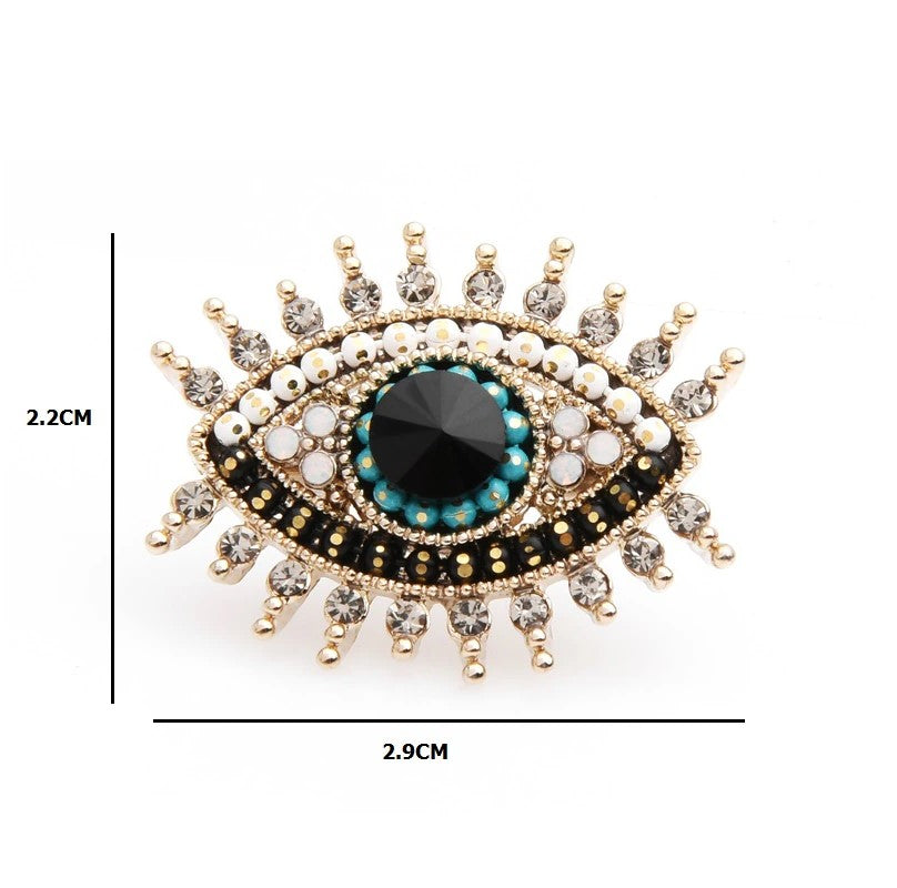 The eye lapel pin styled on a deep blue suit, highlighting its elegant design.