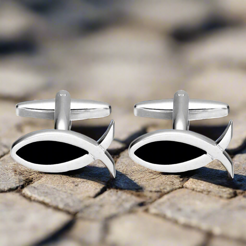 Close-up of elegant Christian Fish cufflinks showcasing their chrome black finish, ideal for formal wear.