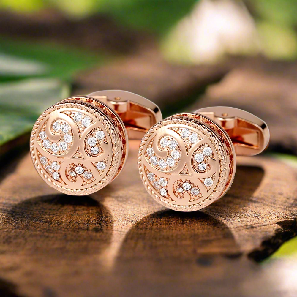 Close-up of rose gold cylinder cufflinks on a white shirt, showcasing their elegance.