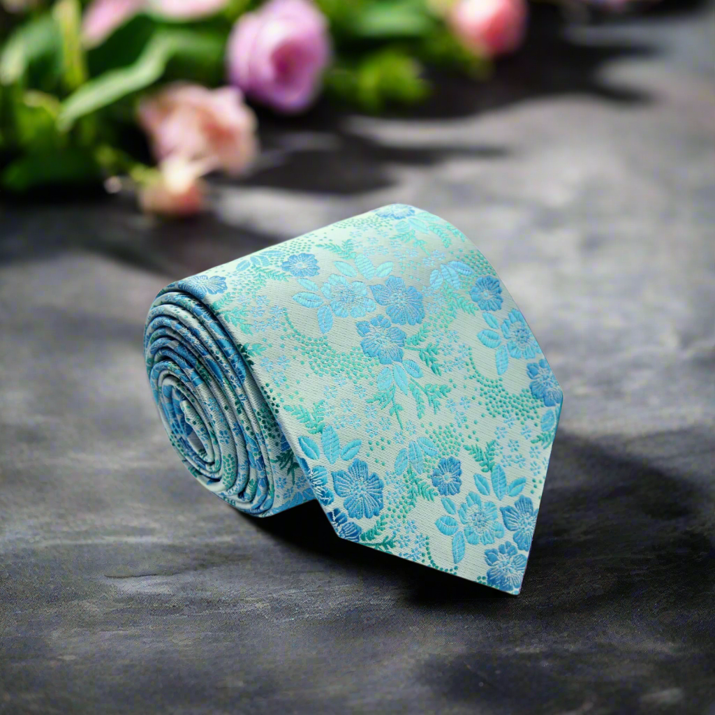 Close-up of the elegant ice blue floral silk tie showing intricate floral patterns.