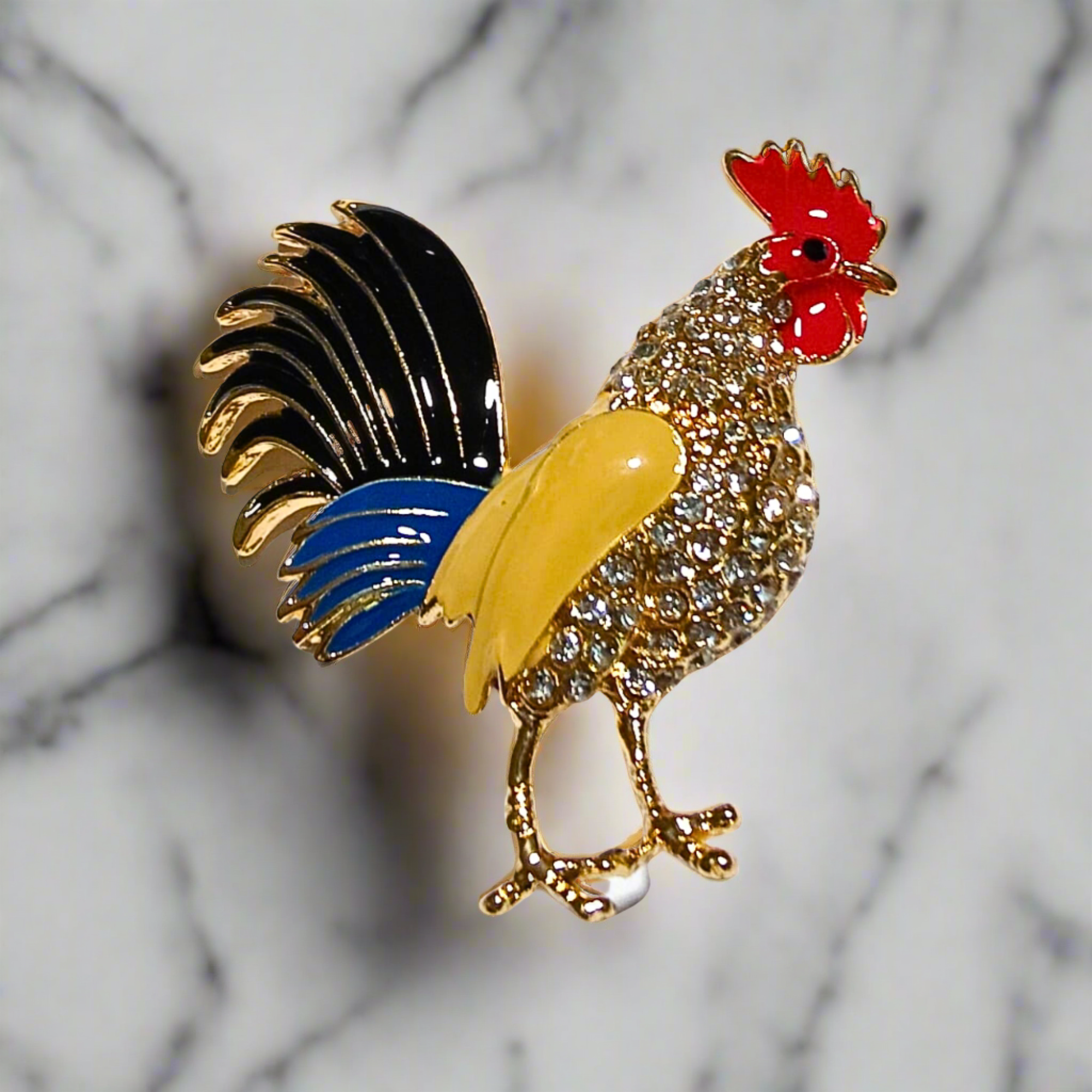 Vibrant rooster gemstone lapel pin on a suit jacket