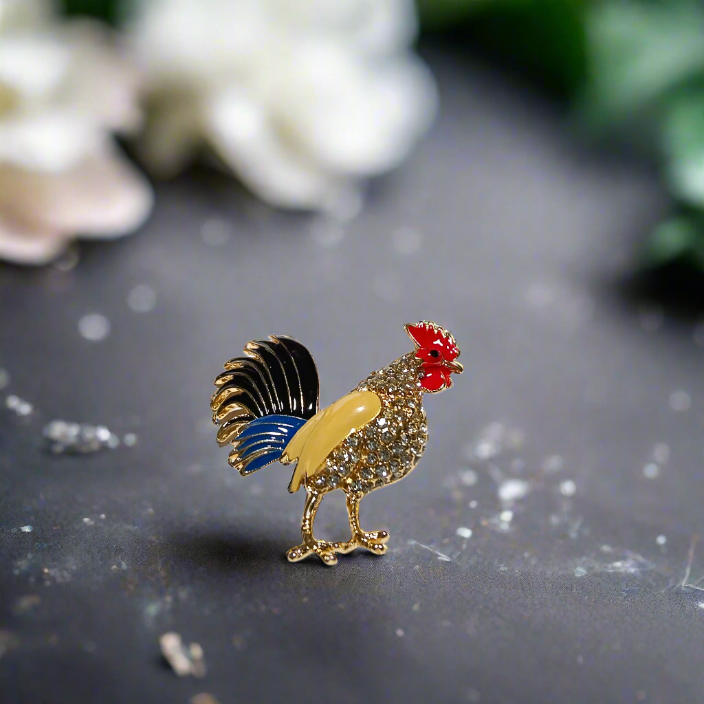 Vibrant rooster gemstone lapel pin on a suit jacket