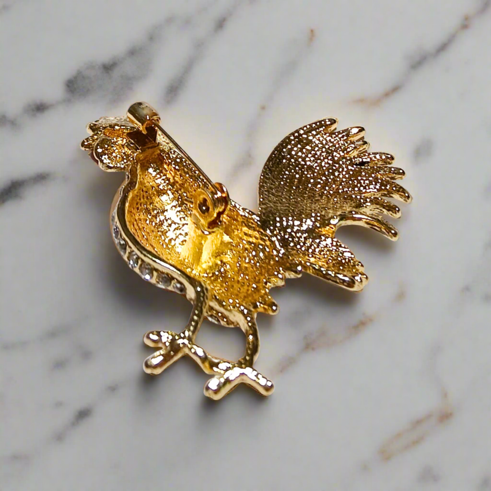 Model wearing rooster lapel pin at a formal event
