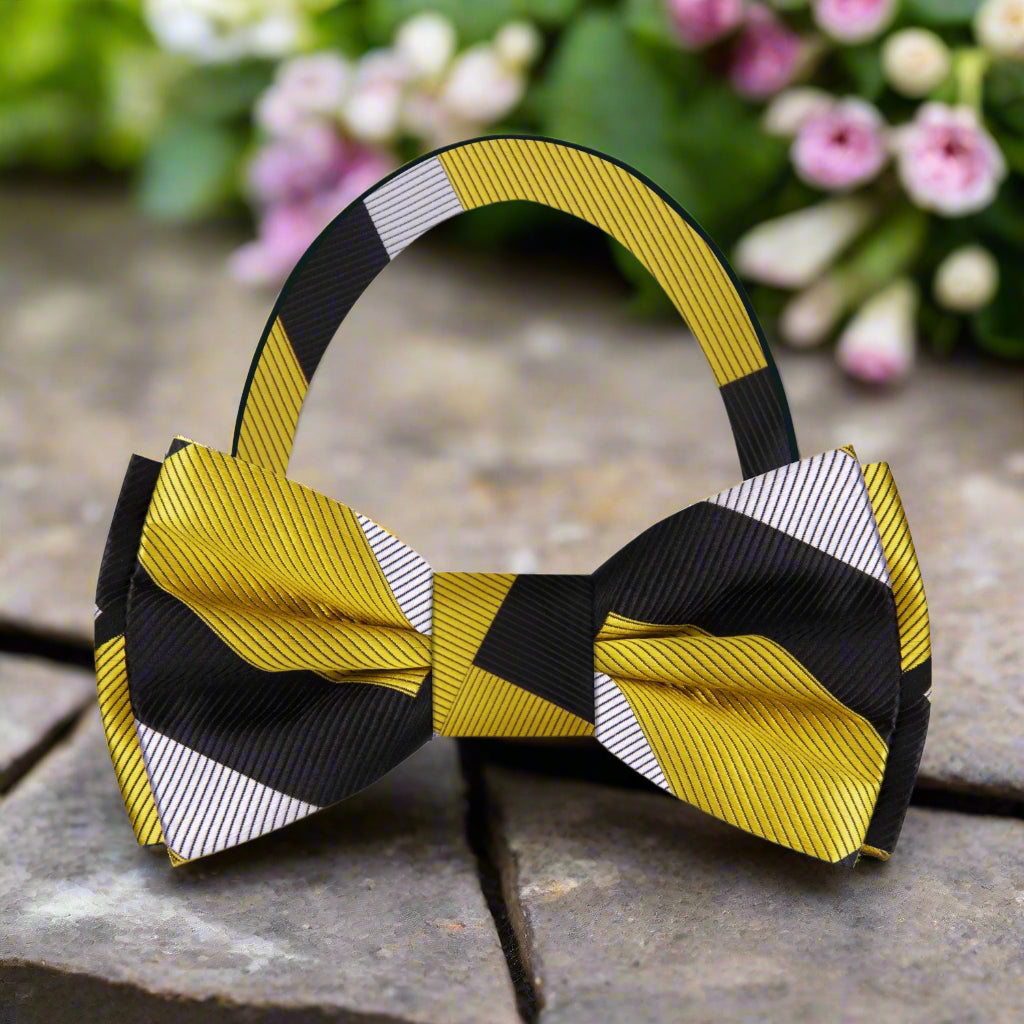 Styled on a pale grey micro-houndstooth shirt with a charcoal suit, showcasing the bow tie’s formal versatility