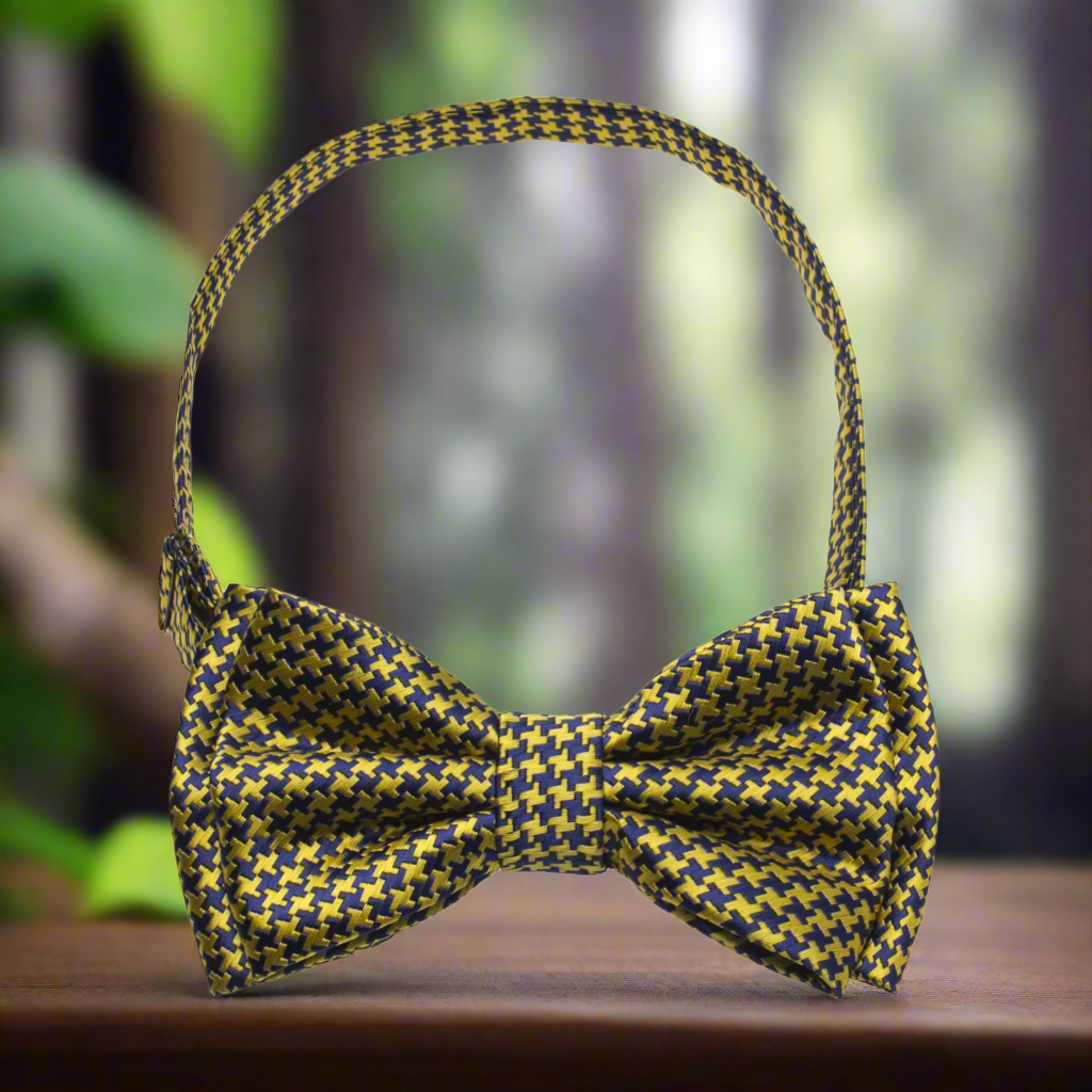 Self-tie houndstooth silk bow tie paired with a navy suit for wedding attire