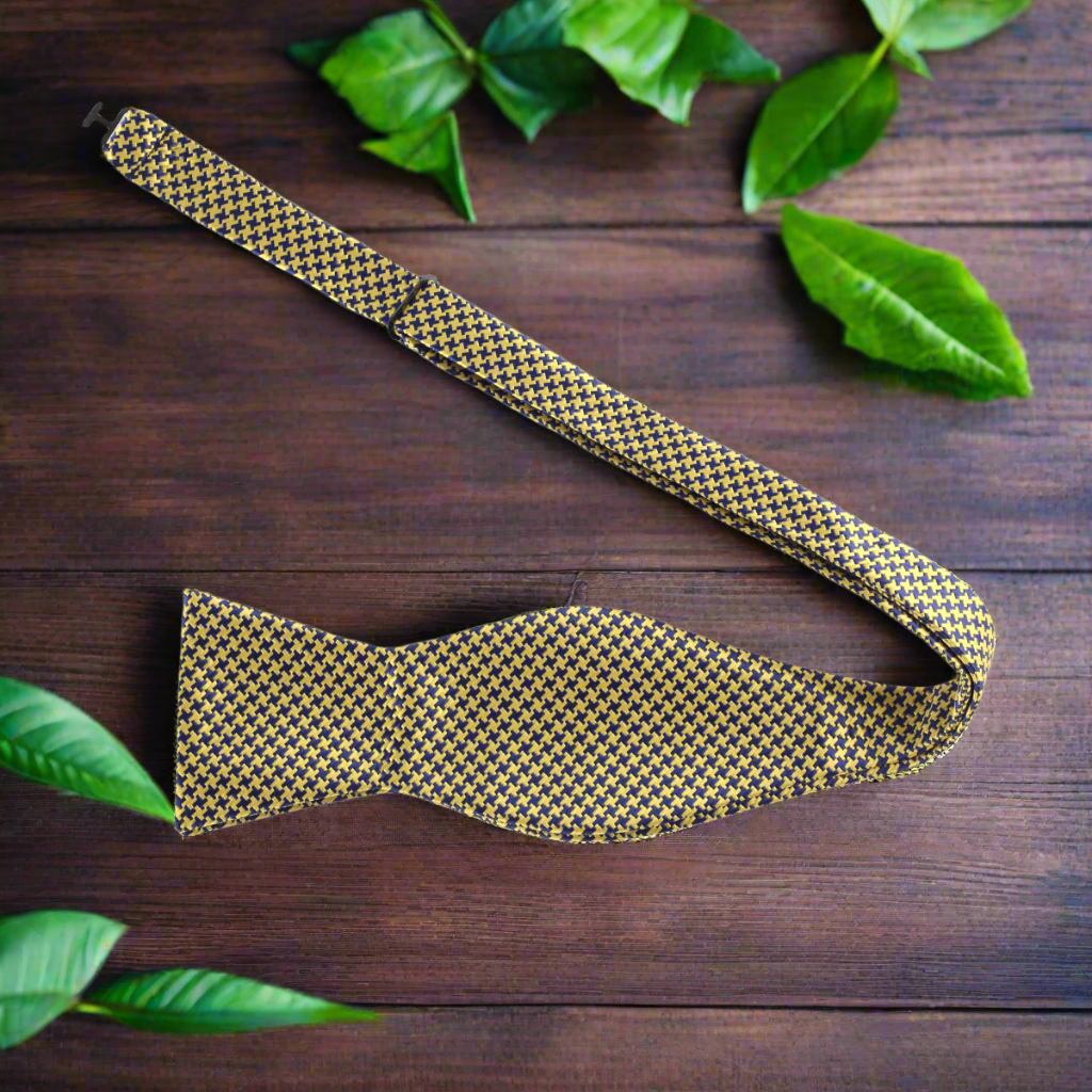 Close-up of a red houndstooth silk bow tie on a dress shirt for formal events