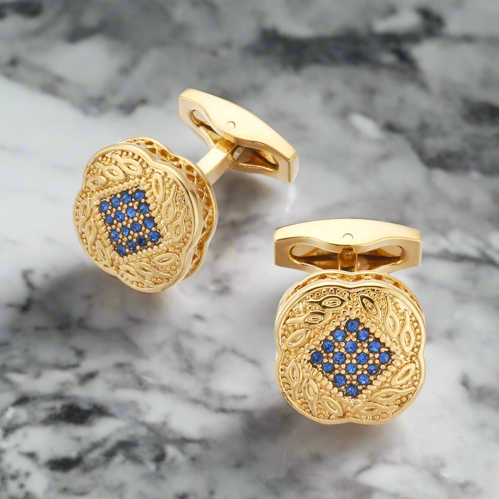 Elegant gold square cufflinks with blue stones on a dress shirt