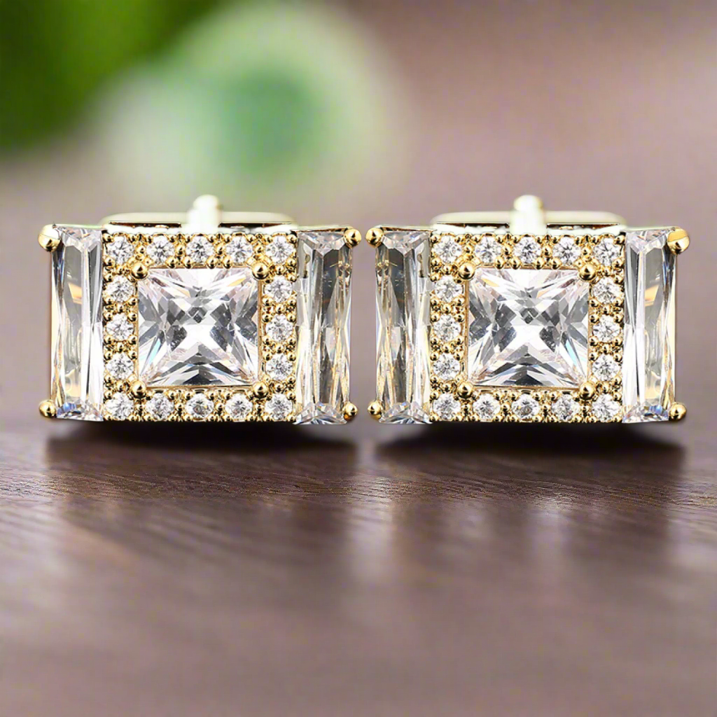 Gold gemstone cufflinks with clear stones, showcasing a luxurious design.