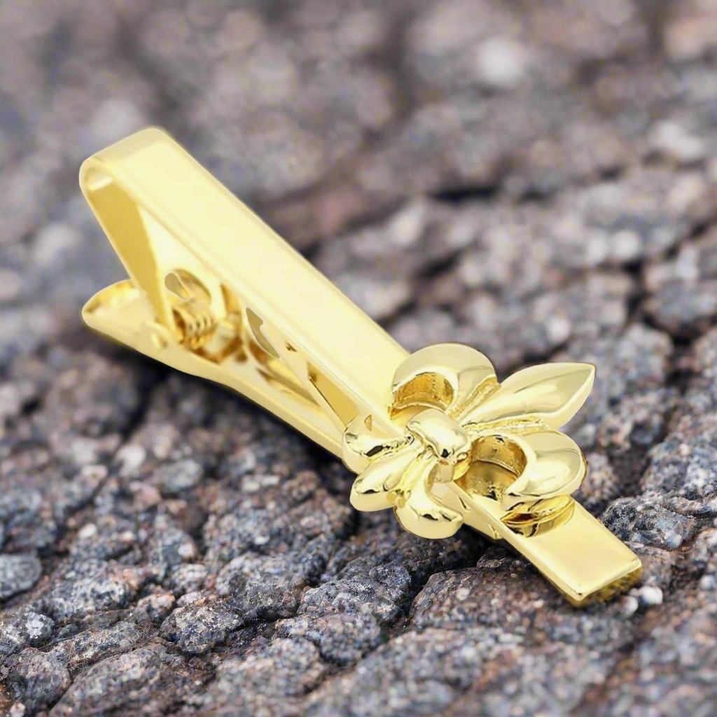 Gold tie clip elegantly displayed with a navy suit, demonstrating its versatility for formal events.